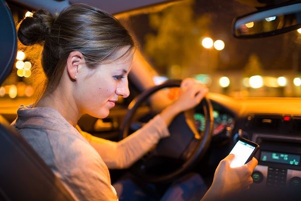 Person driving and on cell phone